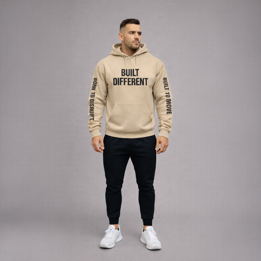 Man wearing a sand hoodie with 'Built Different' text on a gray background