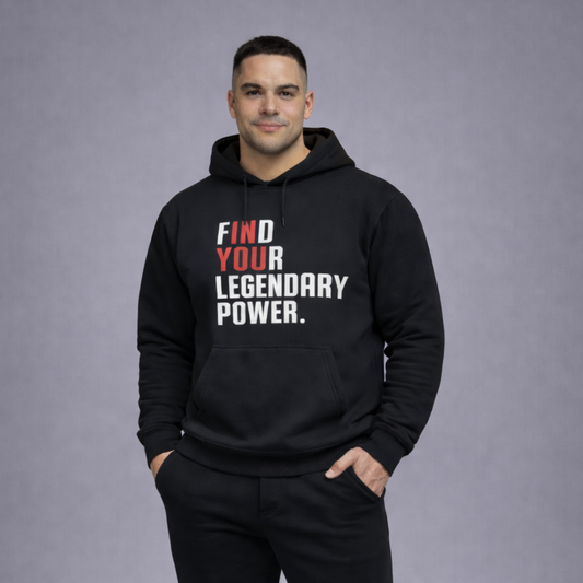 Man wearing a black hoodie with motivational text on a gray background