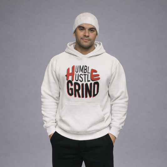 Person wearing a white hoodie with 'Humble Hustle Grind' text, black pants, and white sneakers on a gray background
