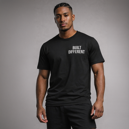 Man wearing a black t-shirt with 'BUILT DIFFERENT' text on a gray background