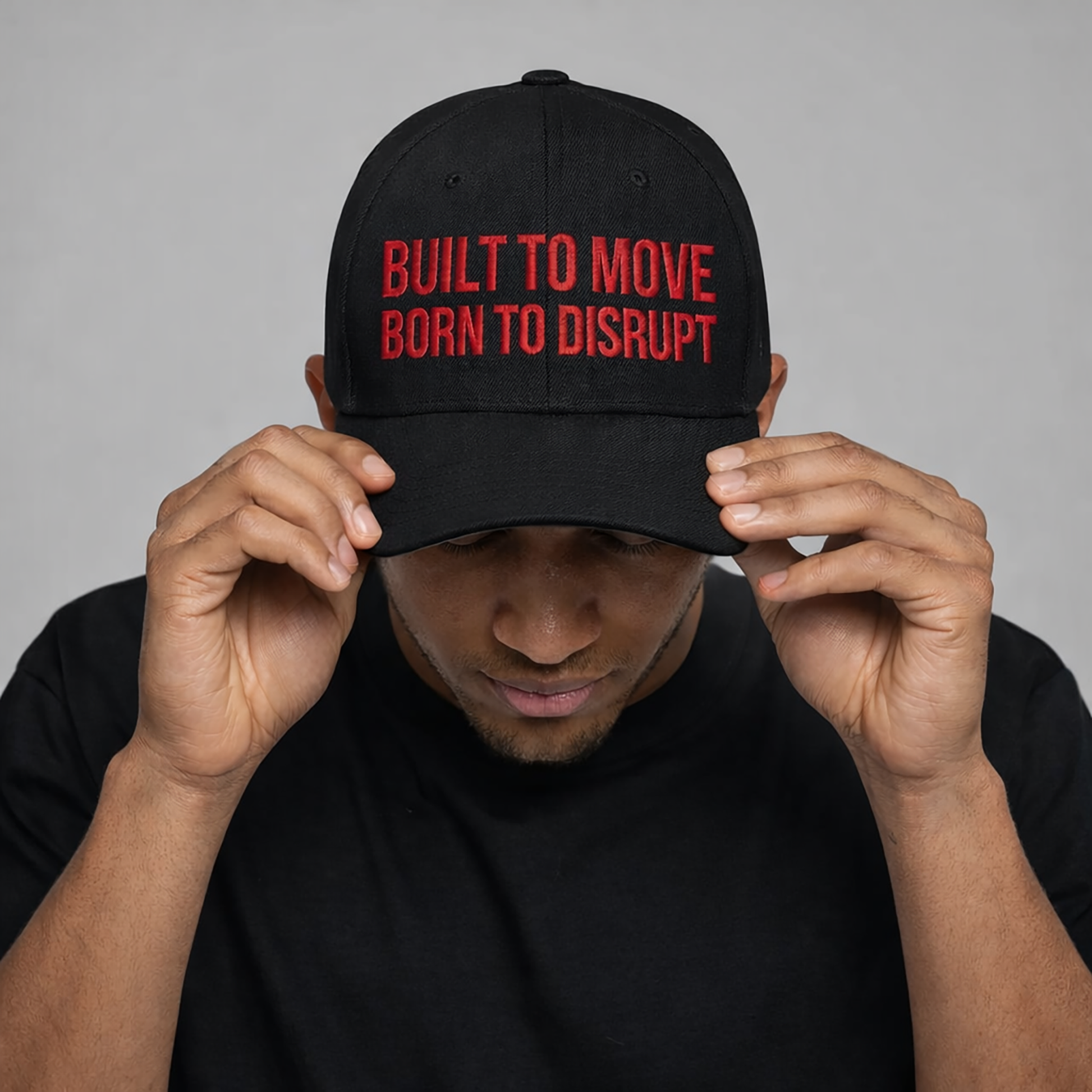 Person wearing a black cap with red text on a gray background