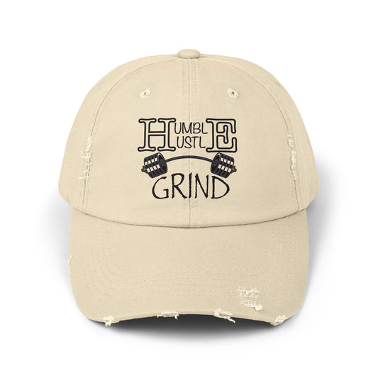 Beige cap with 'Humble Hustle Grind' text and dumbbell graphics on a white background