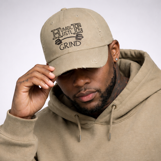 Man wearing a olive cap with text and matching hoodie on a light gray background