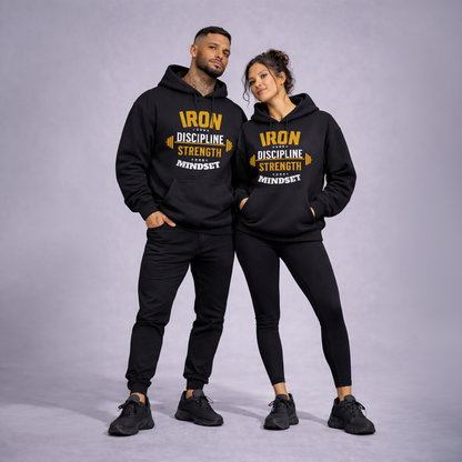 Two people wearing matching black hoodies with yellow text on a gray background